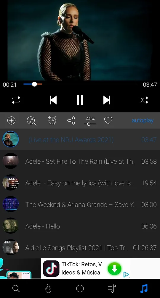 iTube video player with play, pause, skip, repeat and shuffle controls and a queue below